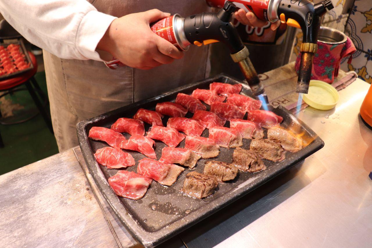 辛辣的韓式小吃在夜市攤位上熱賣，香氣四溢